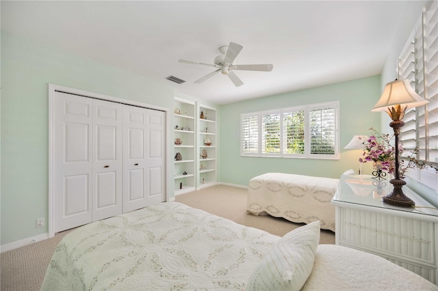 carpeted bedroom with ceiling fan and a closet