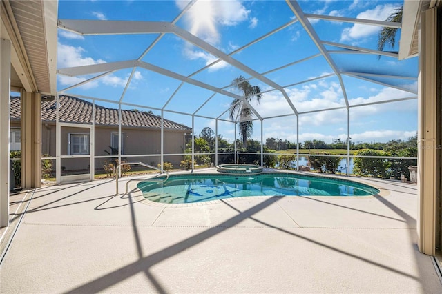 view of pool with an in ground hot tub, a patio, and glass enclosure