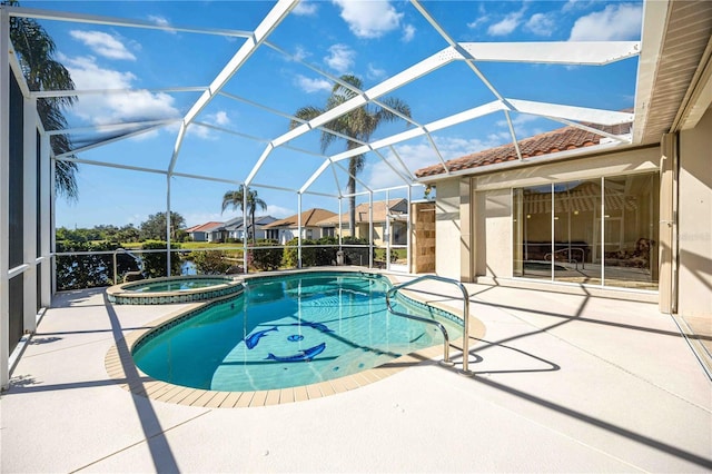 view of pool featuring an in ground hot tub, glass enclosure, and a patio area