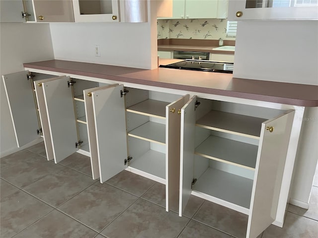 kitchen with white cabinetry and tile patterned flooring