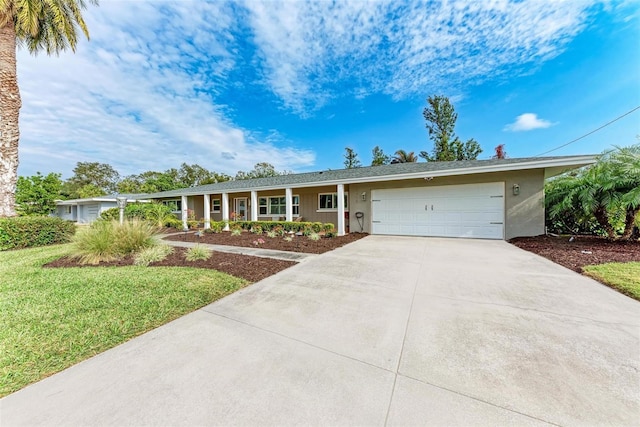 ranch-style home featuring a front yard and a garage