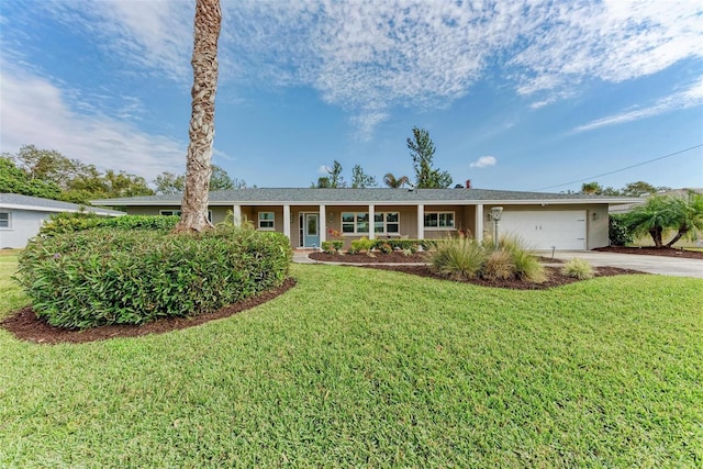 single story home featuring a garage and a front yard