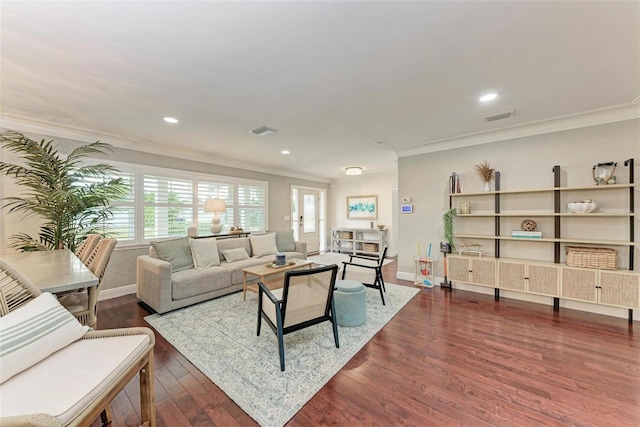 living room with dark wood-type flooring and ornamental molding