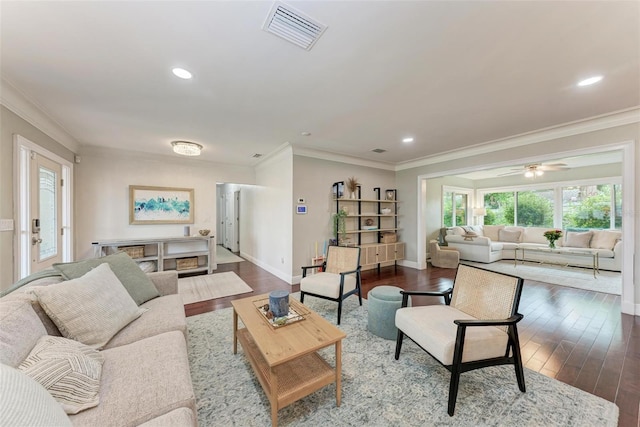 living room with crown molding and hardwood / wood-style floors