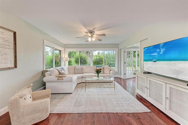 living room featuring ceiling fan and dark hardwood / wood-style floors