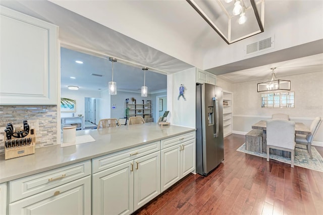 kitchen featuring white cabinetry, pendant lighting, and stainless steel fridge