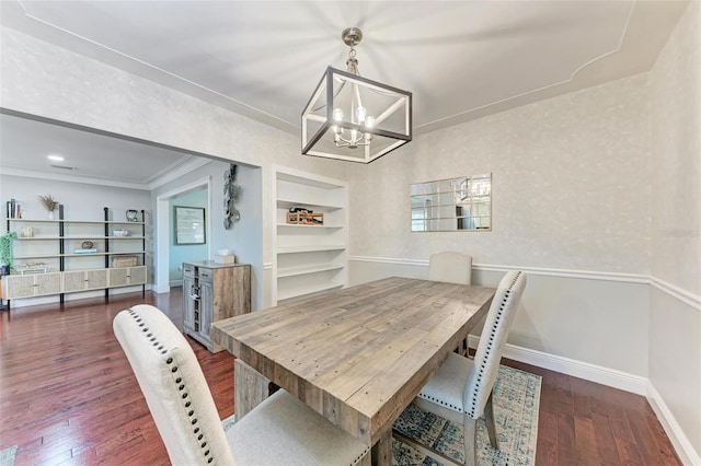 dining space featuring a chandelier, crown molding, dark hardwood / wood-style floors, and built in shelves