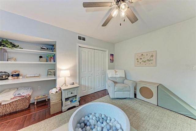 sitting room with ceiling fan and dark hardwood / wood-style floors