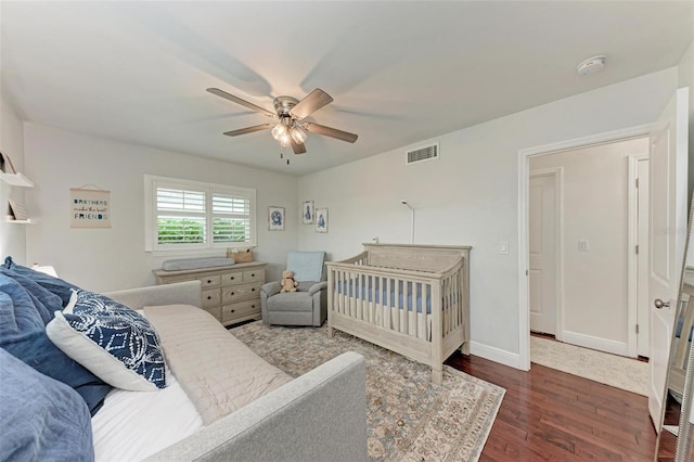 bedroom featuring ceiling fan and dark wood-type flooring