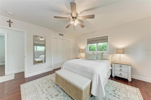 bedroom featuring ceiling fan, a closet, and dark wood-type flooring