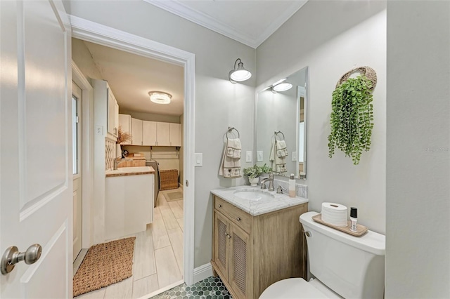 bathroom featuring toilet, tile patterned flooring, crown molding, and vanity