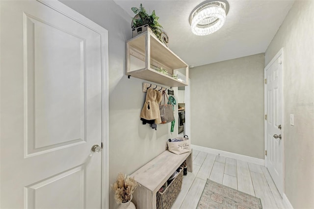 mudroom with light hardwood / wood-style floors