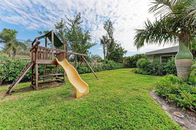 view of jungle gym featuring a lawn