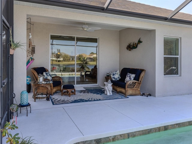 view of patio / terrace featuring ceiling fan and a lanai