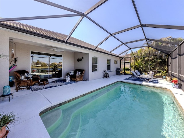 view of swimming pool with a lanai, a patio, and ceiling fan