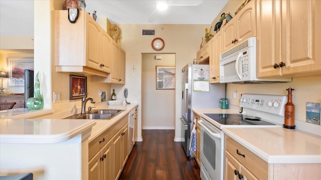 kitchen featuring kitchen peninsula, light brown cabinetry, dark hardwood / wood-style flooring, white appliances, and sink