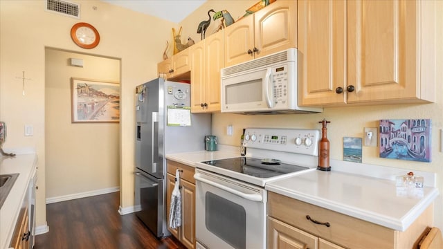 kitchen with white appliances, dark wood-type flooring, and light brown cabinetry