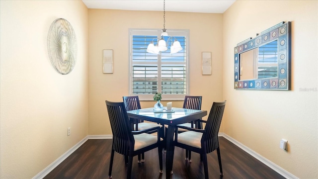 dining room featuring a chandelier and dark wood-type flooring