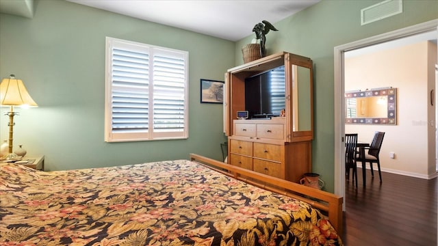 bedroom with dark hardwood / wood-style flooring