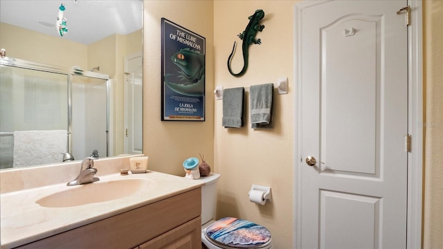 bathroom featuring vanity, toilet, and walk in shower