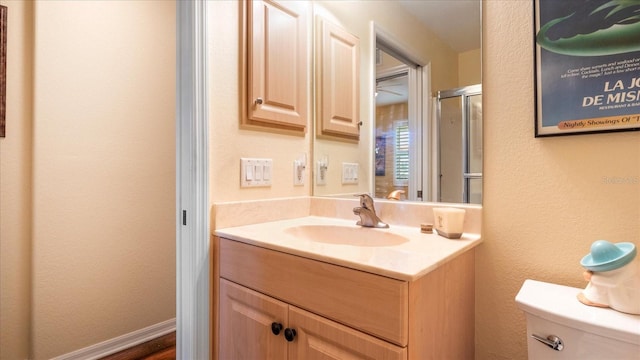 bathroom featuring vanity, toilet, and wood-type flooring