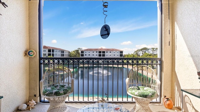 balcony featuring a water view