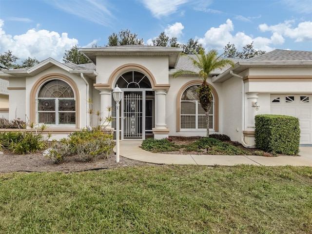 entrance to property with a yard and a garage