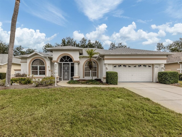 view of front of property featuring a garage and a front yard