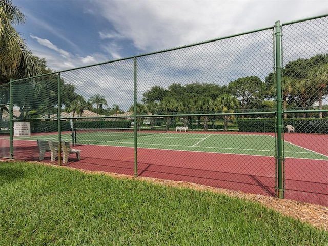 view of sport court featuring a yard