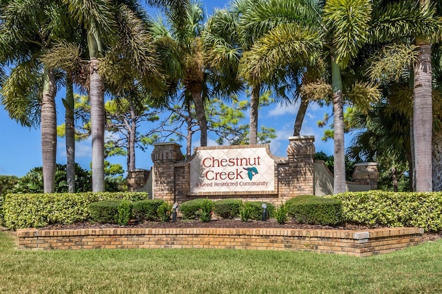 community sign featuring a lawn