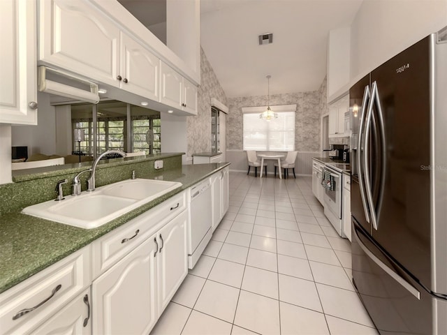 kitchen featuring white cabinetry, sink, white appliances, and light tile patterned floors