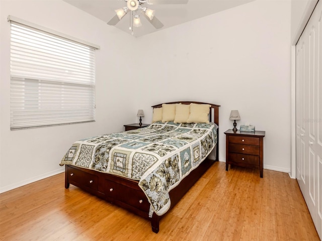 bedroom with light hardwood / wood-style floors, a closet, and ceiling fan