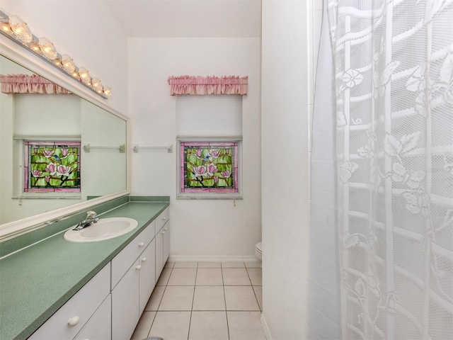 bathroom featuring vanity, tile patterned floors, and toilet