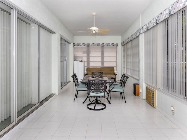 sunroom / solarium featuring ceiling fan