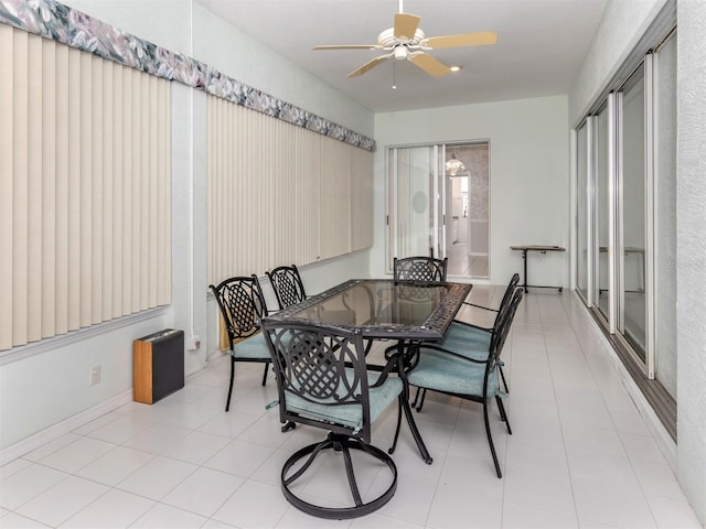 tiled dining space with ceiling fan