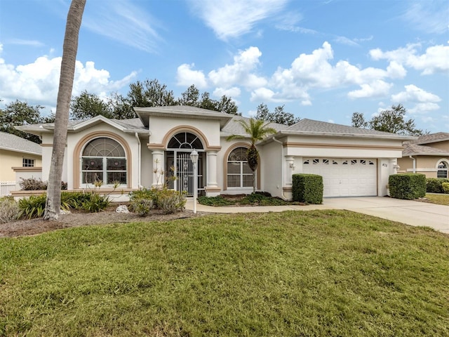 view of front of house with a garage and a front yard