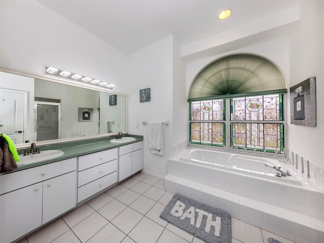 bathroom featuring tile patterned flooring, vanity, and plus walk in shower