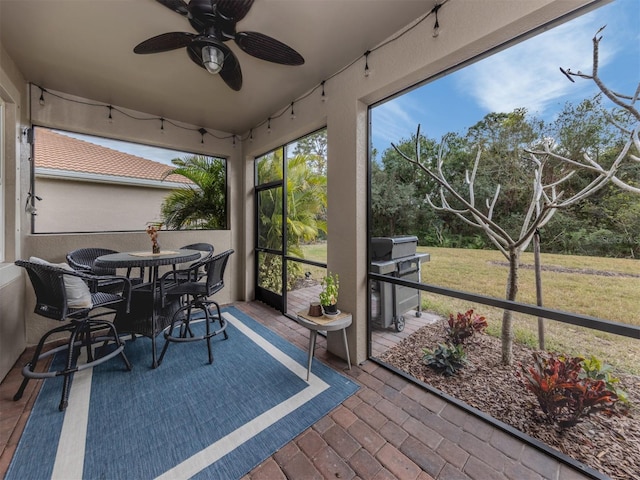 sunroom featuring ceiling fan