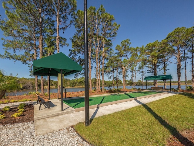 surrounding community featuring a yard and a water view