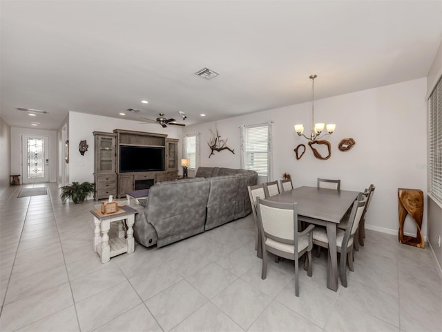 dining area with ceiling fan with notable chandelier, light tile patterned floors, baseboards, visible vents, and recessed lighting