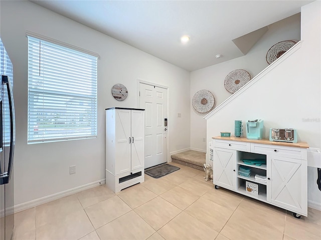 foyer entrance featuring a wealth of natural light and light tile patterned flooring