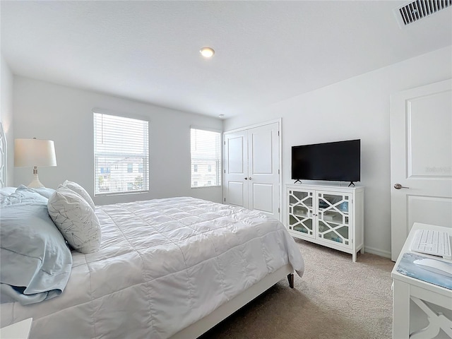 bedroom featuring carpet and a closet