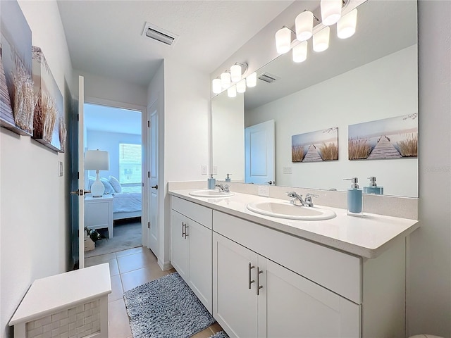 bathroom featuring tile patterned flooring and vanity