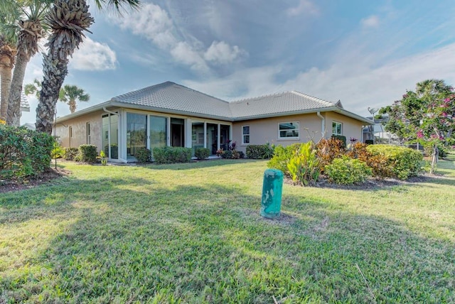 rear view of property with a yard