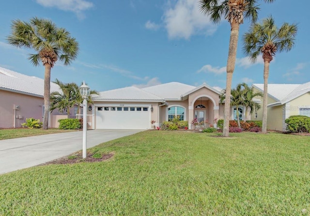 single story home featuring a garage and a front lawn