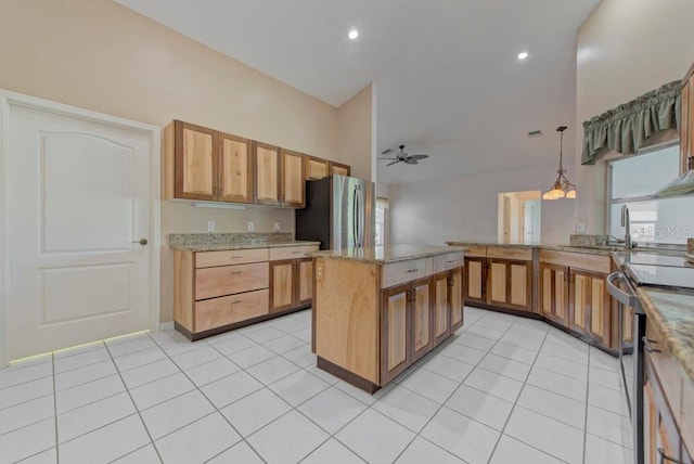 kitchen with a kitchen island, decorative light fixtures, light tile patterned floors, ceiling fan, and stainless steel appliances