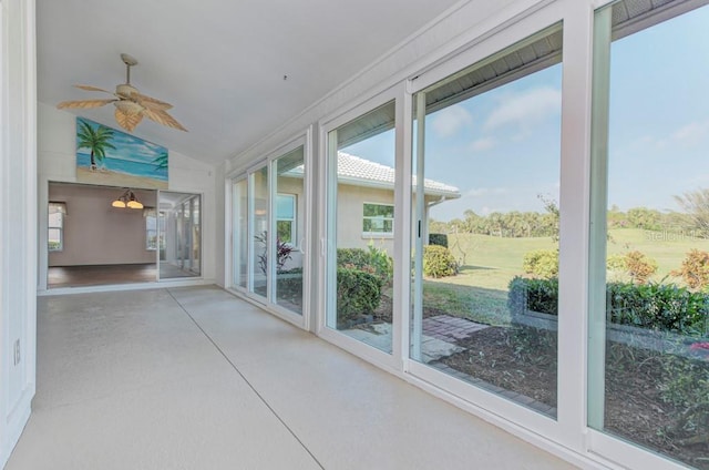 unfurnished sunroom featuring vaulted ceiling and ceiling fan