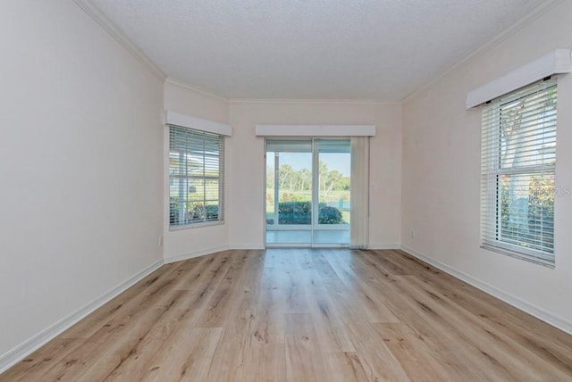 unfurnished room featuring crown molding, light hardwood / wood-style flooring, and a textured ceiling