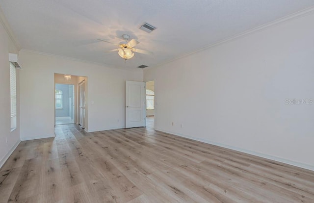 spare room with ornamental molding, ceiling fan, and light hardwood / wood-style floors