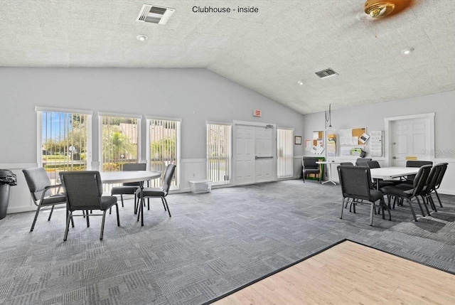 dining space featuring wood-type flooring and lofted ceiling